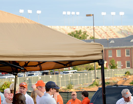 Canopy with tan top during a tailgate.