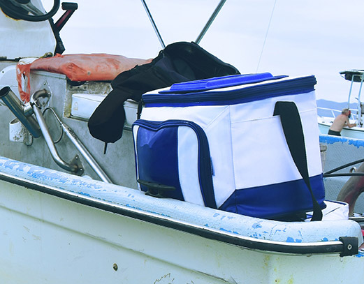 Cooler sitting on the ege of a boat.